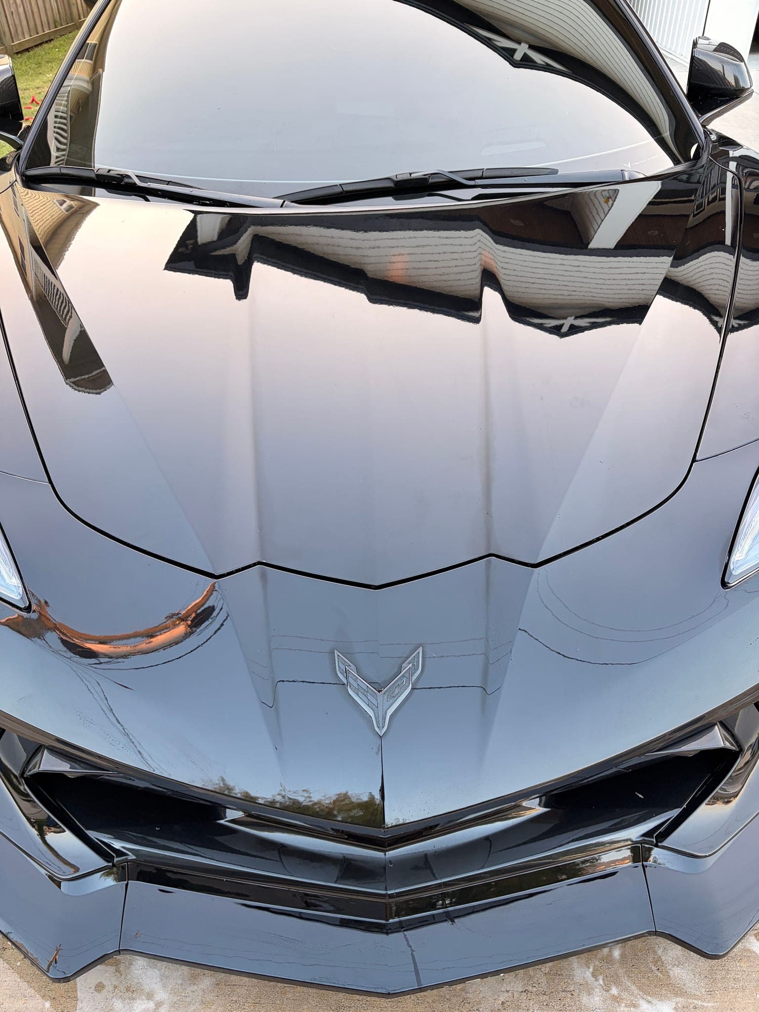 Chevrolet bowtie badge on the Corvette's glossy black hood